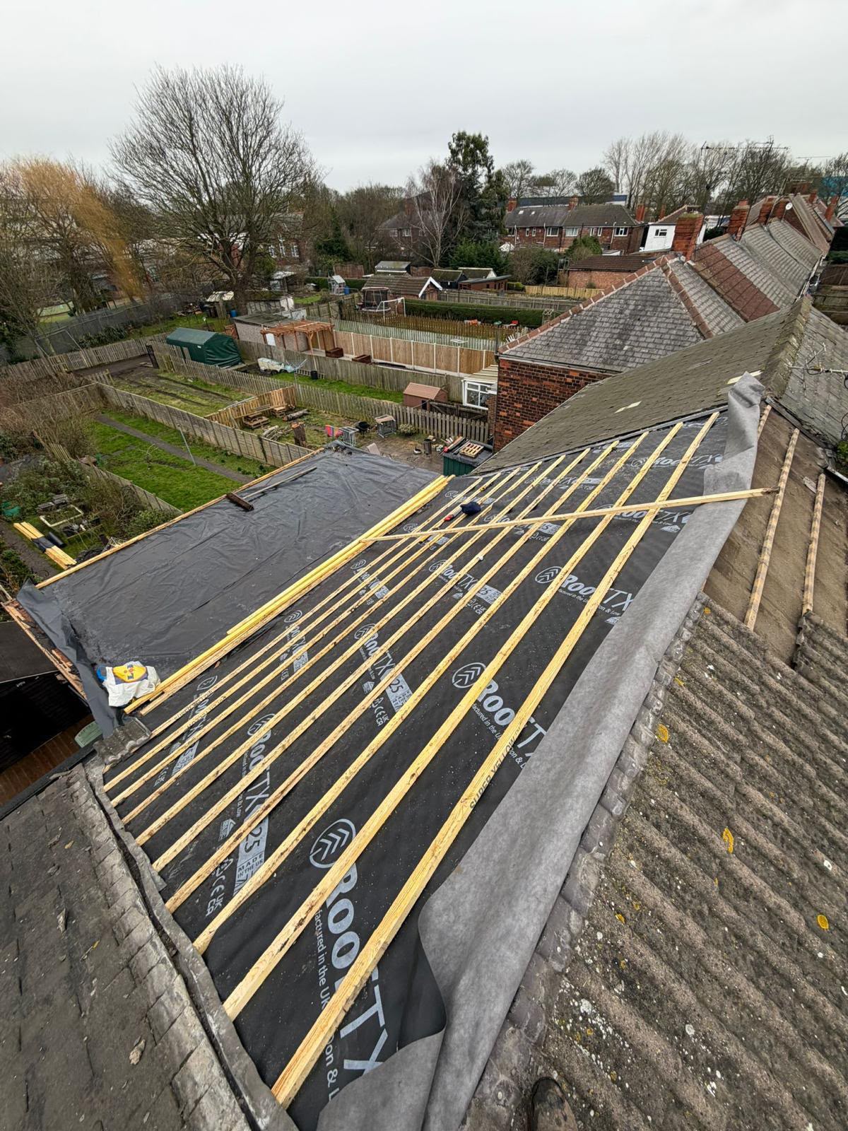 Black roofing membrane and treated timber battens in progress on a residential roof