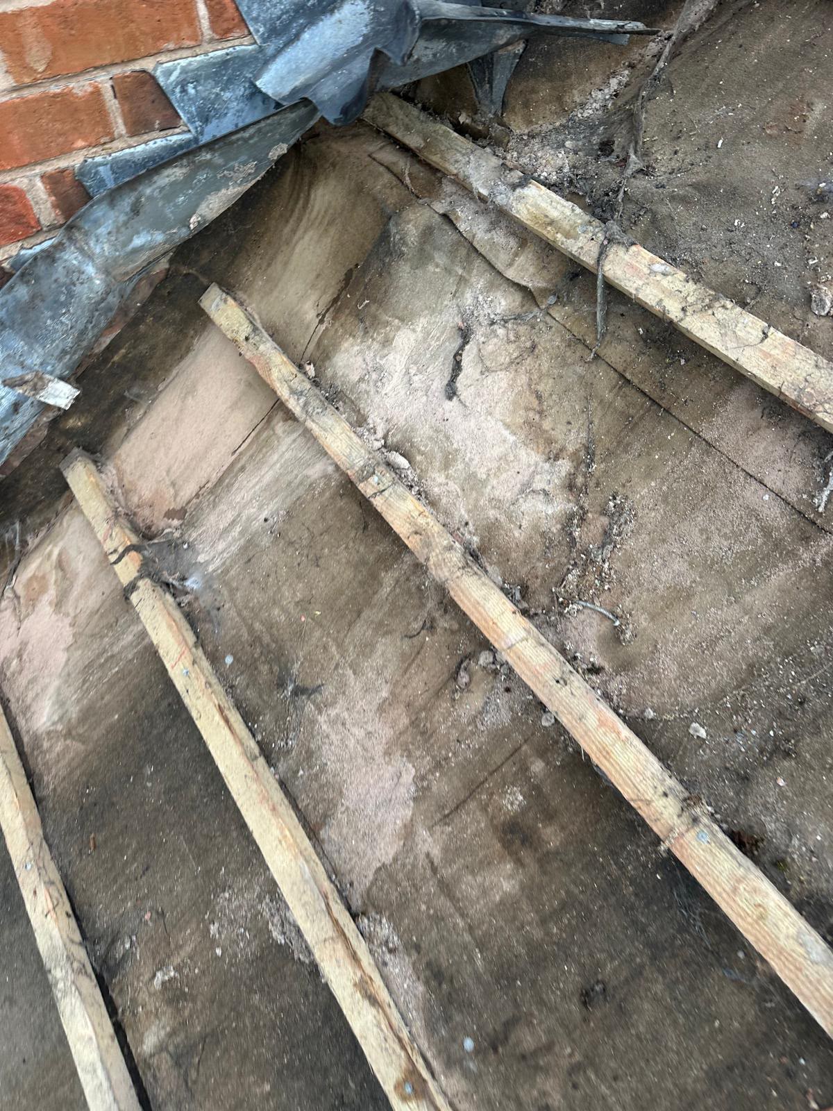 Old perished chimney lead flashing and battens exposed prior to lead work renewal